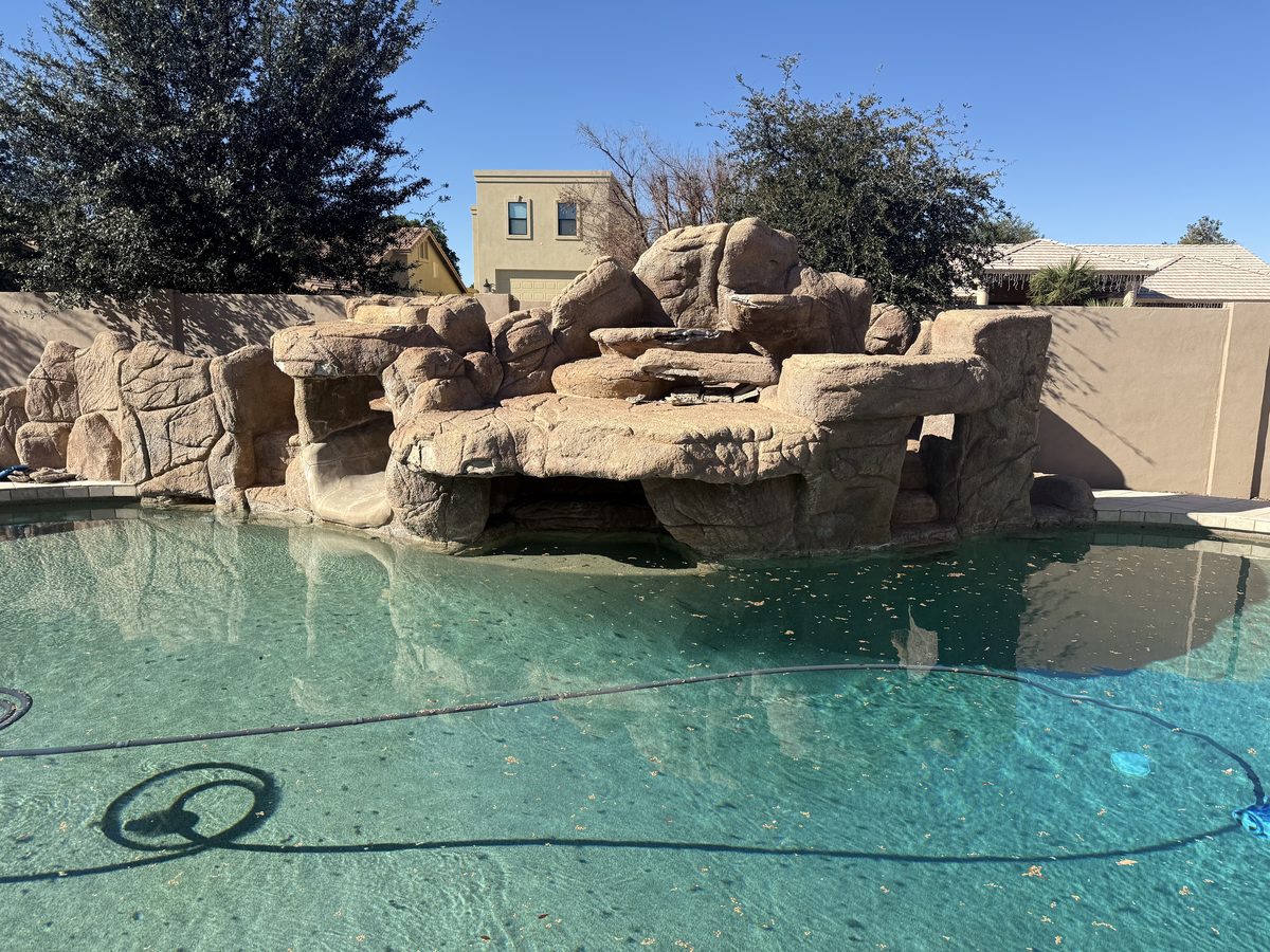 Pool with rock grotto feature during deep clean service